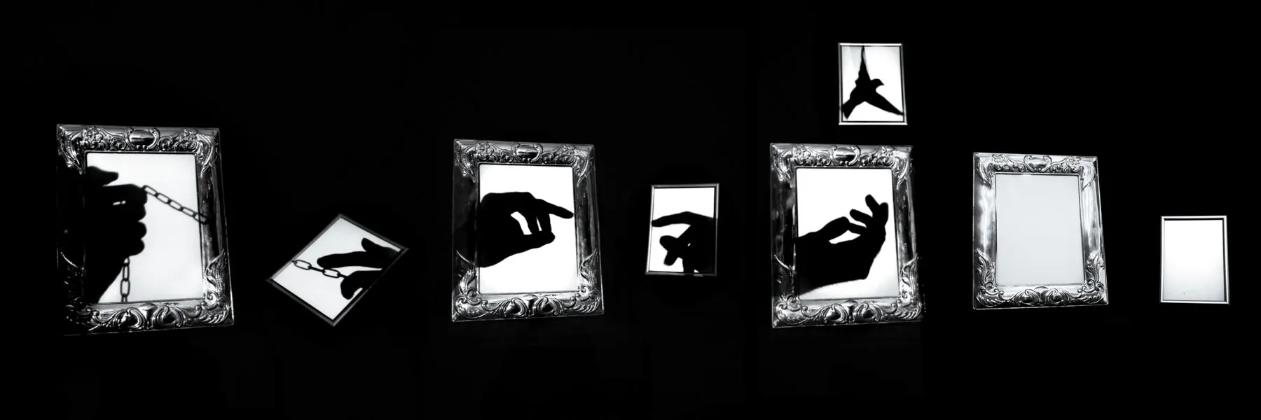 Graphic collage of ornate white picture frames and outstretched hands against black